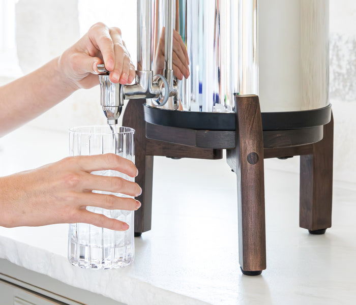 Woman filling a glass at gravity filter