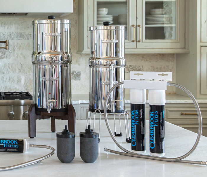 Clearbrook dual under-sink filter system installed beneath a kitchen sink